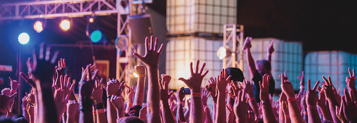 People at a concert with their hands in the air