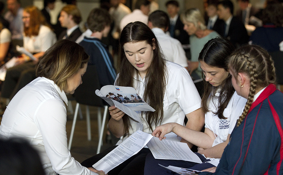 Students looking at pamphlets