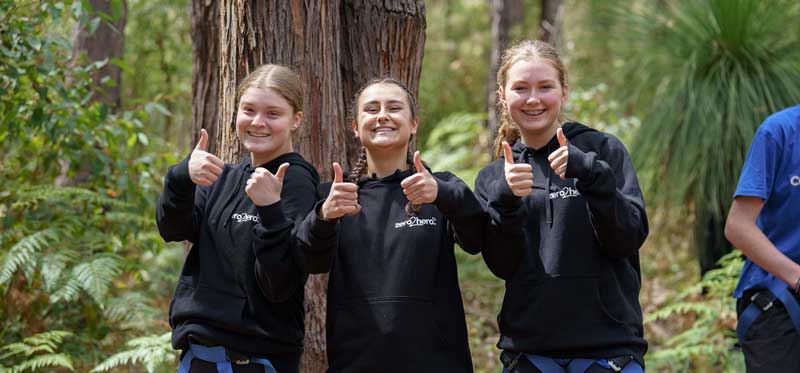 Three camp hero participants give a thumbs up to the camera.