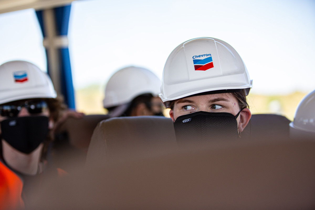 Student wearing hard hat on the flight to Chevron-operated Wheatstone with RTS On Tour