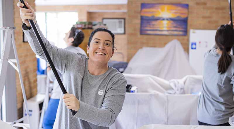 Members of Chevron Australia's Women Network doing volunteer painting work at a Zonta House refuge.