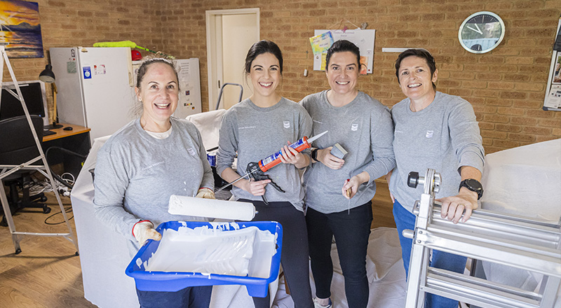 Members of Chevron Australia's Women Network doing volunteer painting work at a Zonta House refuge.