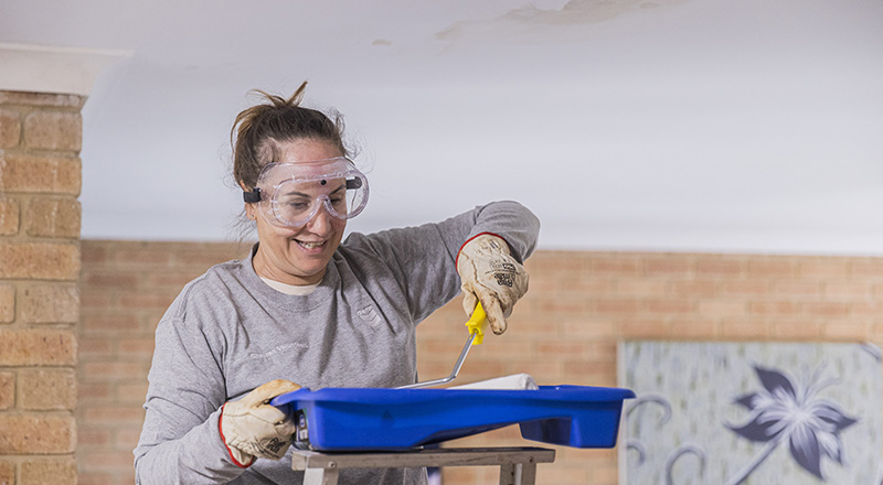 Members of Chevron Australia's Women Network doing volunteer painting work at a Zonta House refuge.